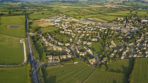 An aerial view of a village in the countryside.