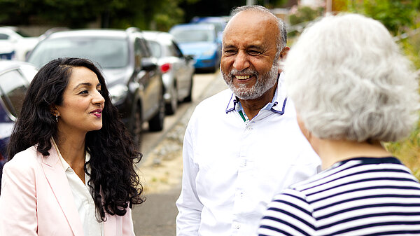 Nazmeen and Mo chatting to resident 