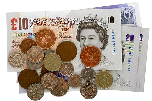 A pile of coins on notes. 